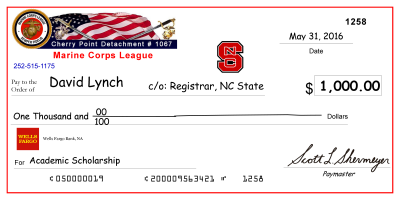 image of large-scale mock check presented to previous scholarship recipient, David Lynch